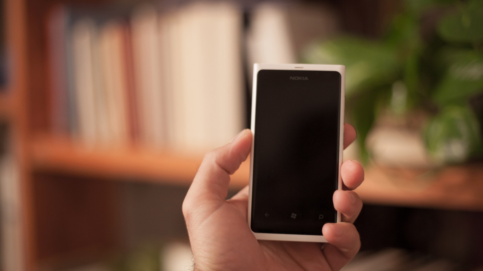 A person holding a smartphone in one hand.